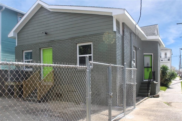 3533 S Liberty St, New Orleans, LA 70115 - view of side of home featuring brick siding and a gate