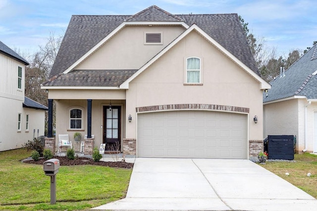 view of front of home with a porch, a garage, and a front yard