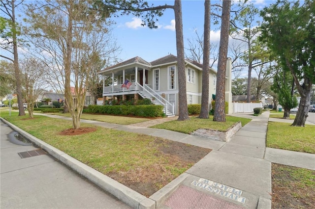 view of property exterior featuring a porch and a lawn