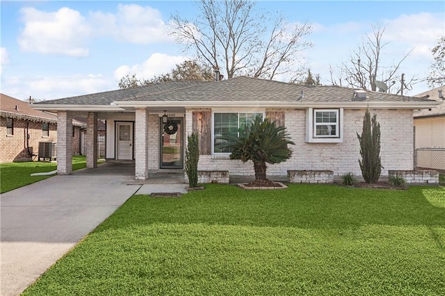 view of front facade featuring a carport, a front yard, and central air condition unit