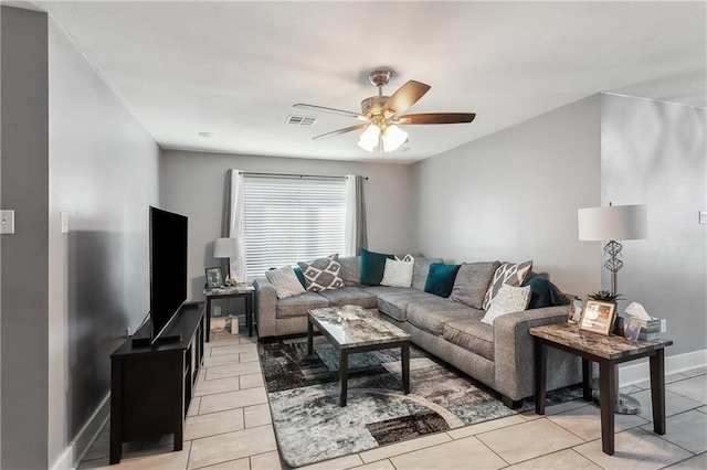 tiled living room with ceiling fan