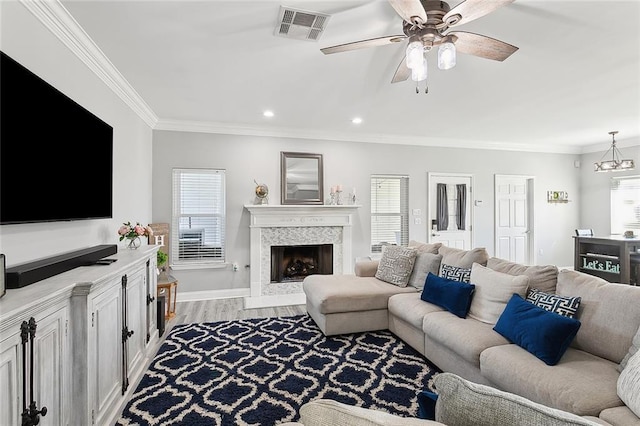 1125 Kingswood Dr, Westwego, LA 70094 - living room with a wealth of natural light, a tile fireplace, visible vents, and ornamental molding