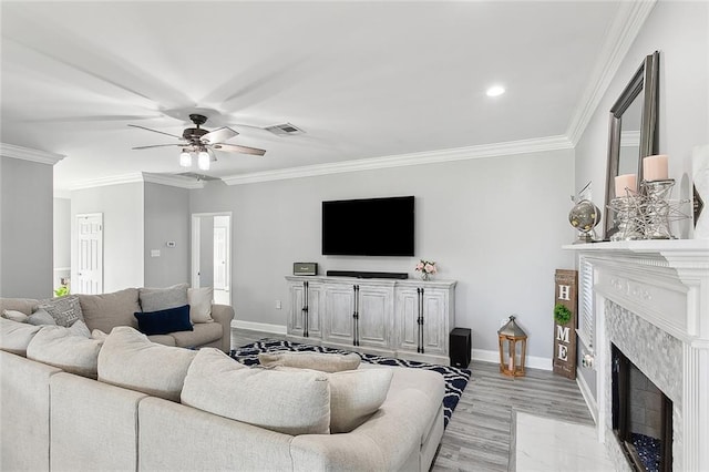 1125 Kingswood Dr, Westwego, LA 70094 - living room featuring a high end fireplace, visible vents, ornamental molding, and ceiling fan