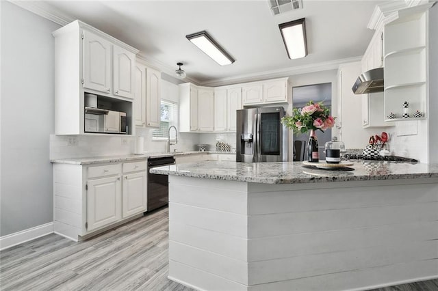 kitchen featuring stainless steel fridge, white cabinetry, range hood, light stone counters, and kitchen peninsula