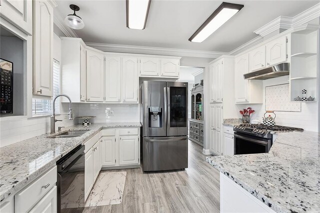 1125 Kingswood Dr, Westwego, LA 70094 - kitchen featuring light stone counters, white cabinets, under cabinet range hood, stainless steel appliances, and a sink