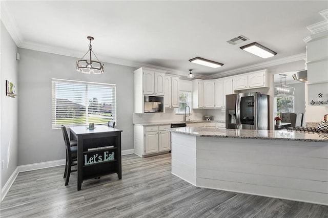 1125 Kingswood Dr, Westwego, LA 70094 - kitchen featuring stainless steel fridge with ice dispenser, visible vents, white cabinetry, and an inviting chandelier