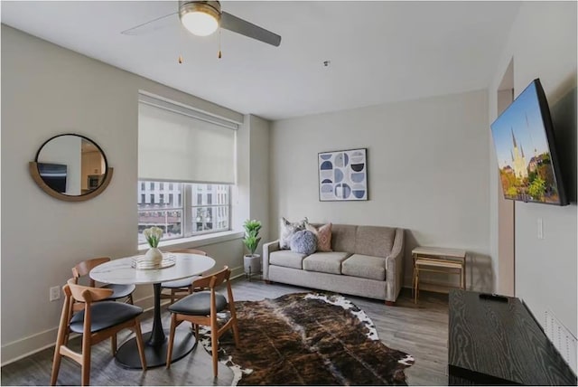 living room with hardwood / wood-style flooring and ceiling fan