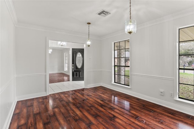 foyer with ornamental molding, visible vents, baseboards, and hardwood / wood-style flooring