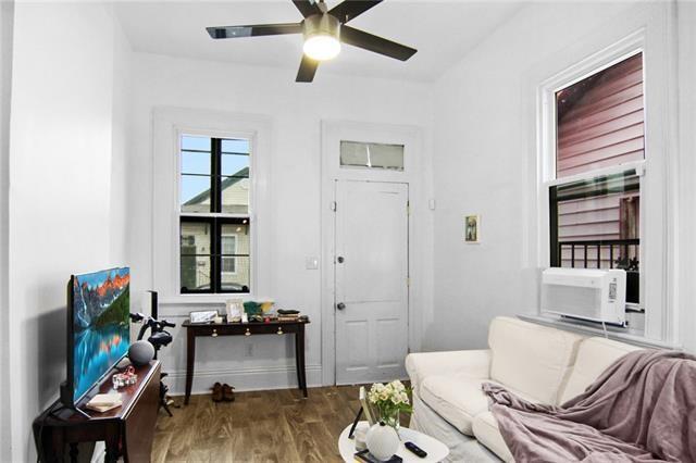 interior space with ceiling fan and dark wood-type flooring