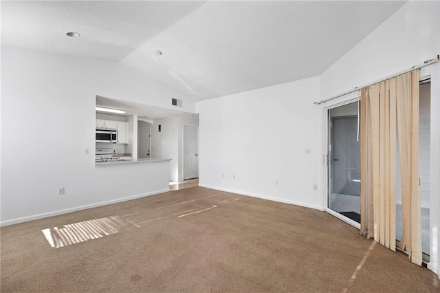 unfurnished living room with lofted ceiling, carpet flooring, baseboards, and visible vents