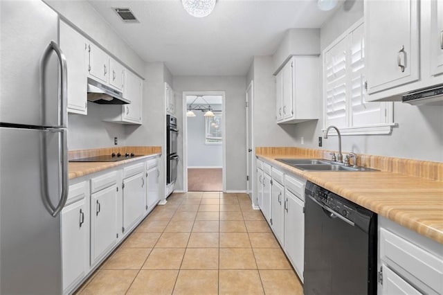 kitchen featuring white cabinetry, sink, black appliances, and light tile patterned flooring