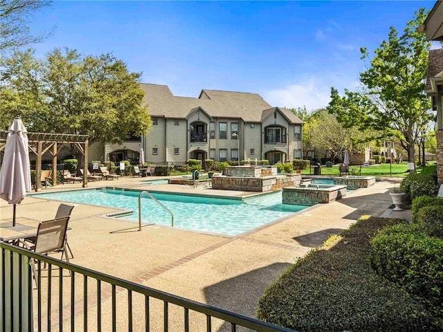 view of swimming pool with a patio area, a pergola, and a pool with connected hot tub