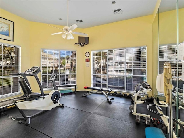 gym with visible vents, baseboards, and ceiling fan