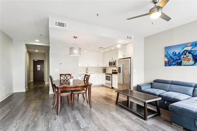 dining area featuring hardwood / wood-style flooring and ceiling fan