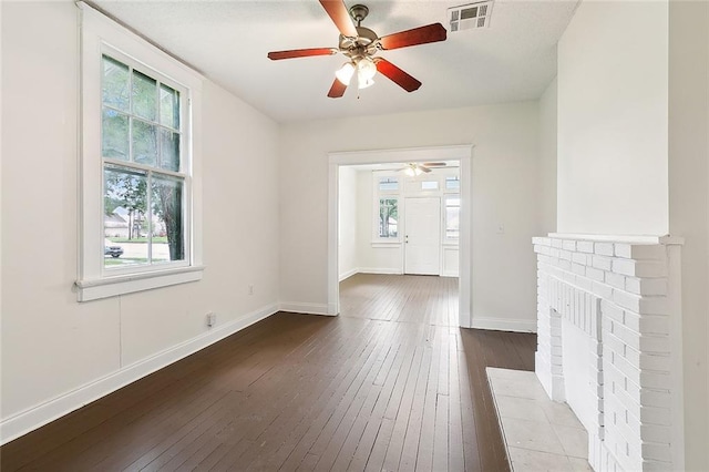 833537 S Claiborne Ave, New Orleans, LA 70118 - unfurnished living room featuring ceiling fan, baseboards, visible vents, and dark wood finished floors