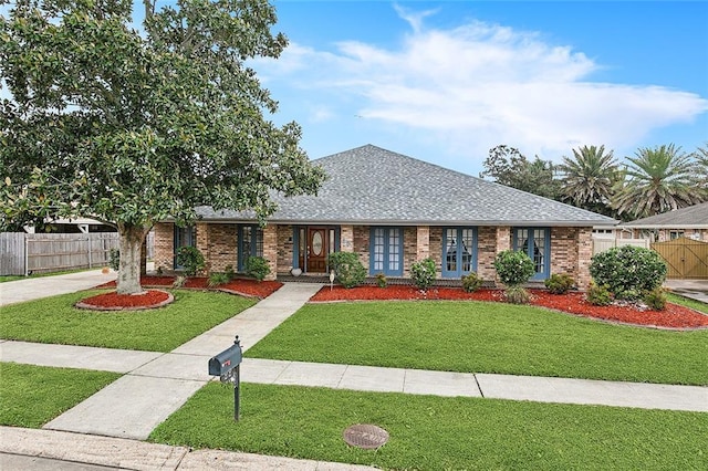 ranch-style house featuring a front lawn