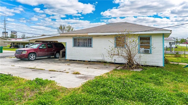 view of side of home with a lawn