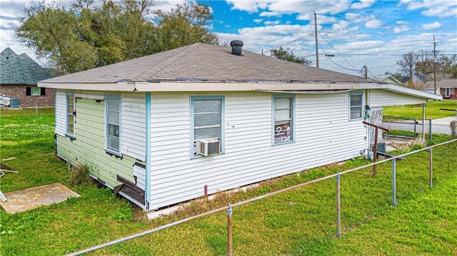 view of side of property with cooling unit and a lawn