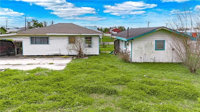 rear view of property with a lawn