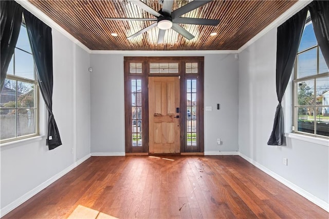 foyer entrance with ornamental molding, hardwood / wood-style floors, and a wealth of natural light