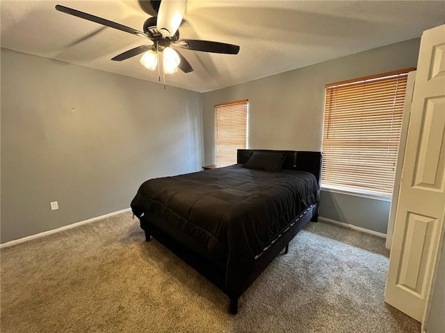 bedroom featuring ceiling fan and carpet