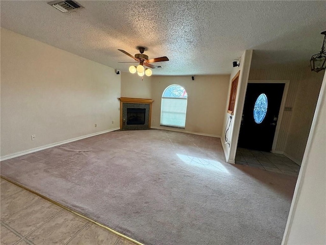 unfurnished living room featuring light carpet, a textured ceiling, and ceiling fan