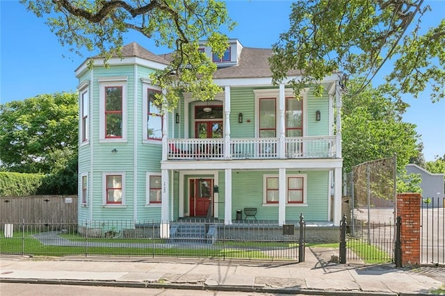 view of front of property featuring a balcony and a porch