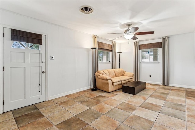 interior space featuring light tile patterned flooring and ceiling fan