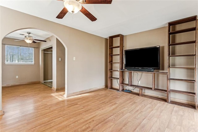 unfurnished living room with ceiling fan and light hardwood / wood-style floors