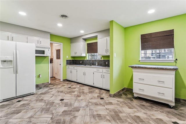 kitchen with white cabinetry, sink, and white appliances