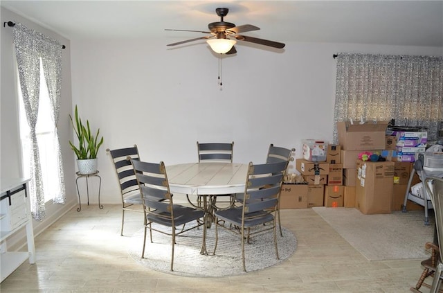 dining space featuring ceiling fan and light hardwood / wood-style flooring