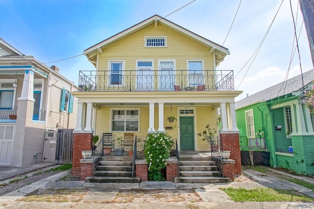 view of front of home with a balcony and covered porch