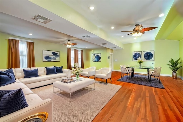 living room with ceiling fan and light hardwood / wood-style floors