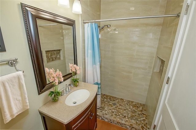 bathroom featuring vanity and a shower with shower curtain