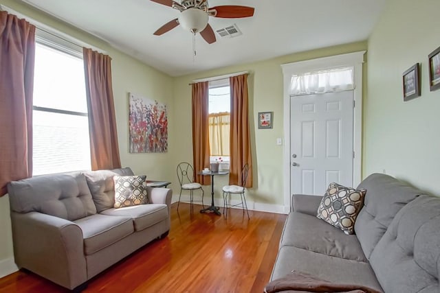 living room with hardwood / wood-style floors and ceiling fan