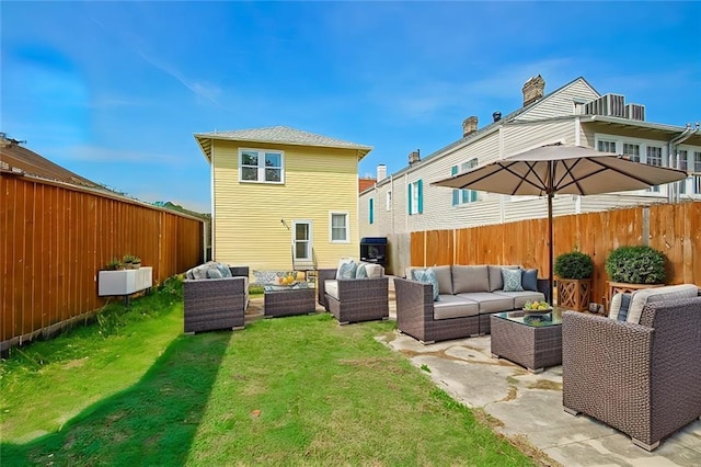 back of property featuring a yard, outdoor lounge area, and a patio area