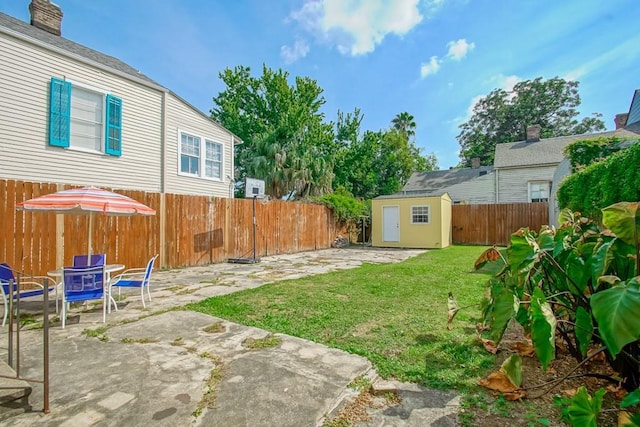 view of yard featuring a storage shed and a patio