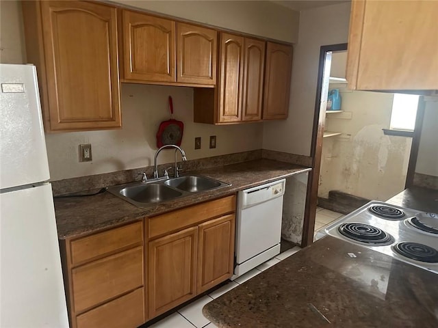 kitchen with light tile patterned flooring, sink, and white appliances