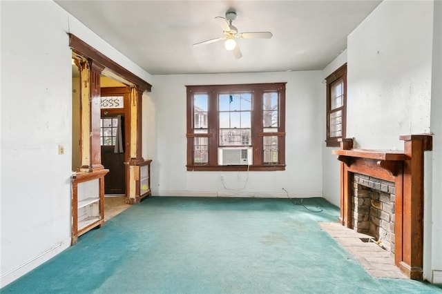 unfurnished living room with cooling unit, a brick fireplace, carpet floors, and ceiling fan