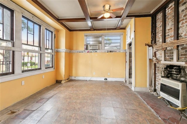 spare room featuring heating unit, ceiling fan, coffered ceiling, and beamed ceiling