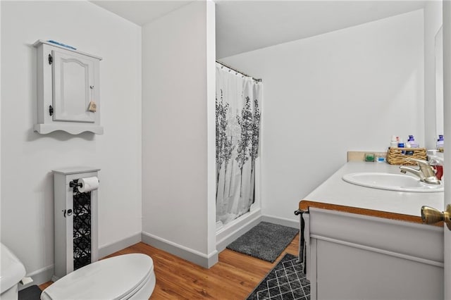 bathroom featuring hardwood / wood-style flooring, vanity, toilet, and a shower with shower curtain