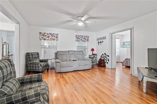 living room featuring ceiling fan and hardwood / wood-style floors