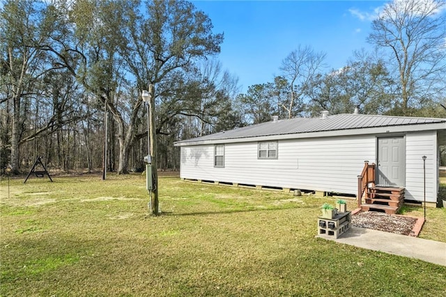 view of side of home with a lawn