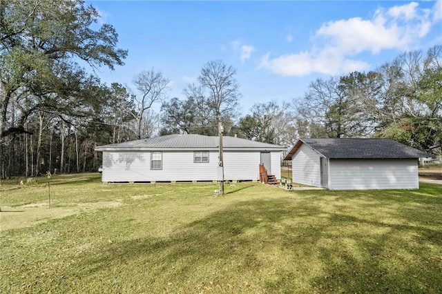 rear view of house featuring a yard