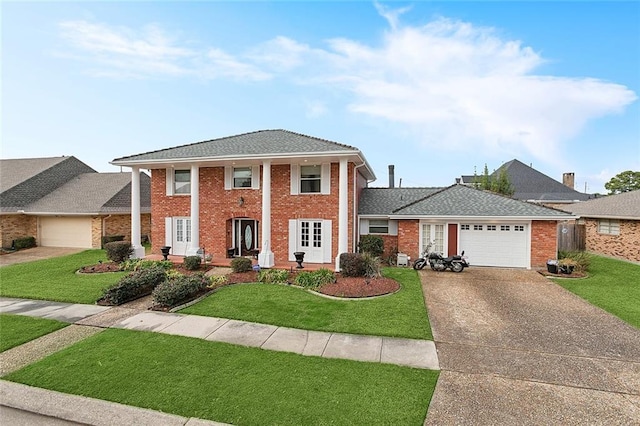 view of front of home featuring a garage and a front yard