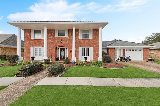 view of front of home featuring a garage and a front yard