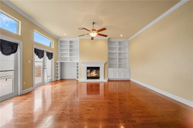 unfurnished living room featuring ornamental molding, wood-type flooring, and built in features