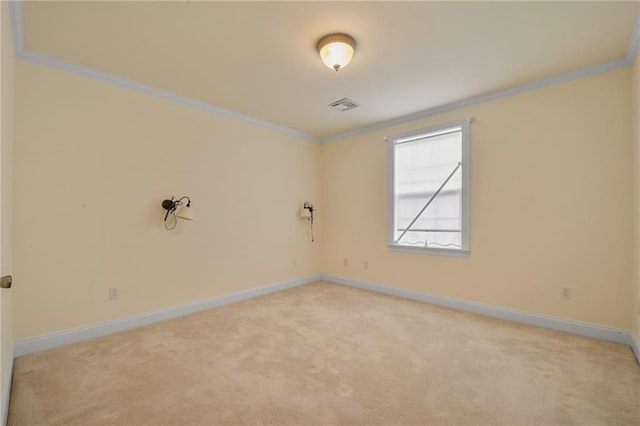 spare room featuring crown molding and light colored carpet