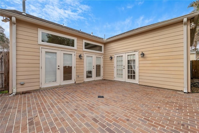 rear view of property featuring a patio and french doors