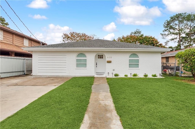 ranch-style home with a front yard, fence, and brick siding